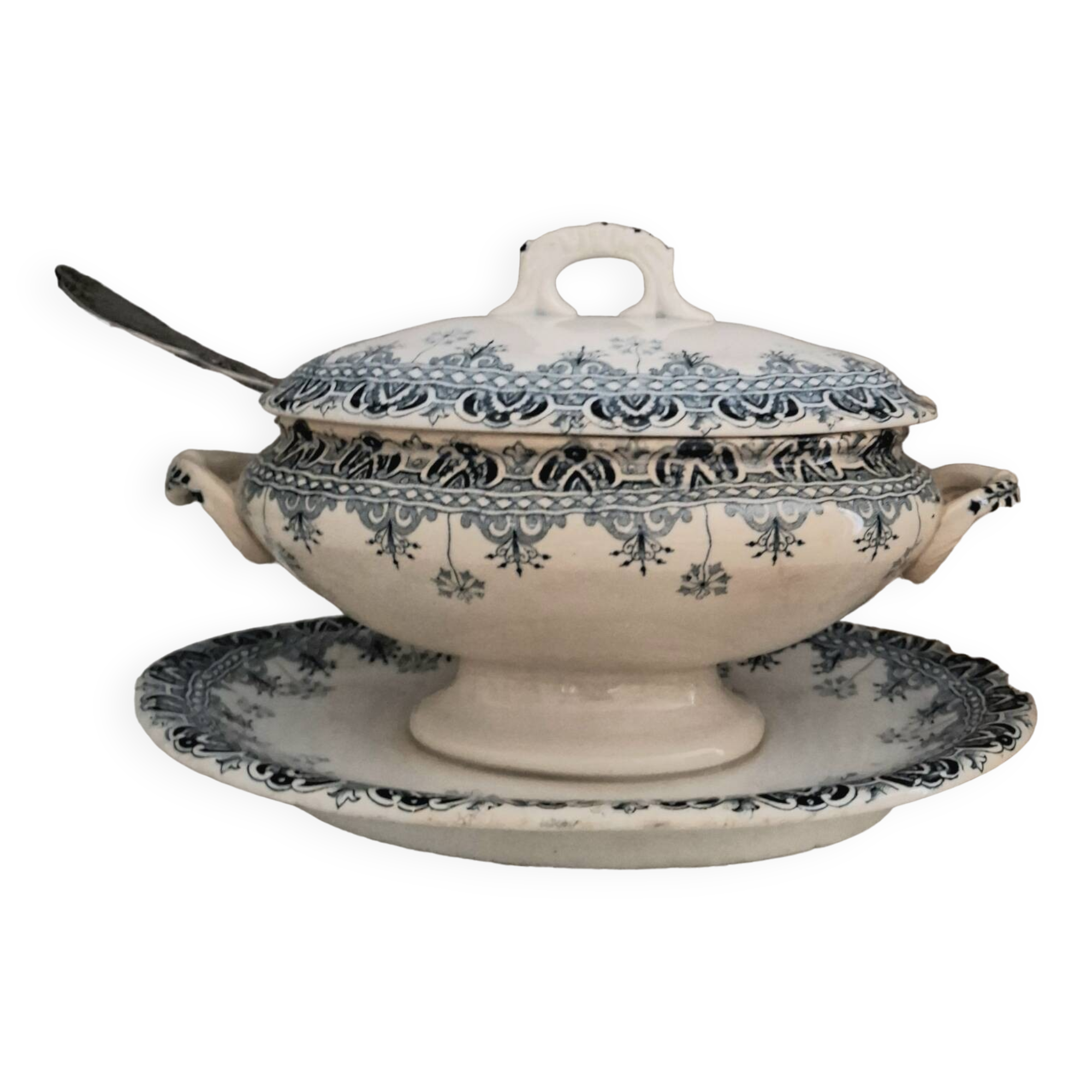 Antique iron earthenware sauceboat on a frame