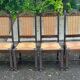 4 Basque solid wood dining chairs with carved straw seats.