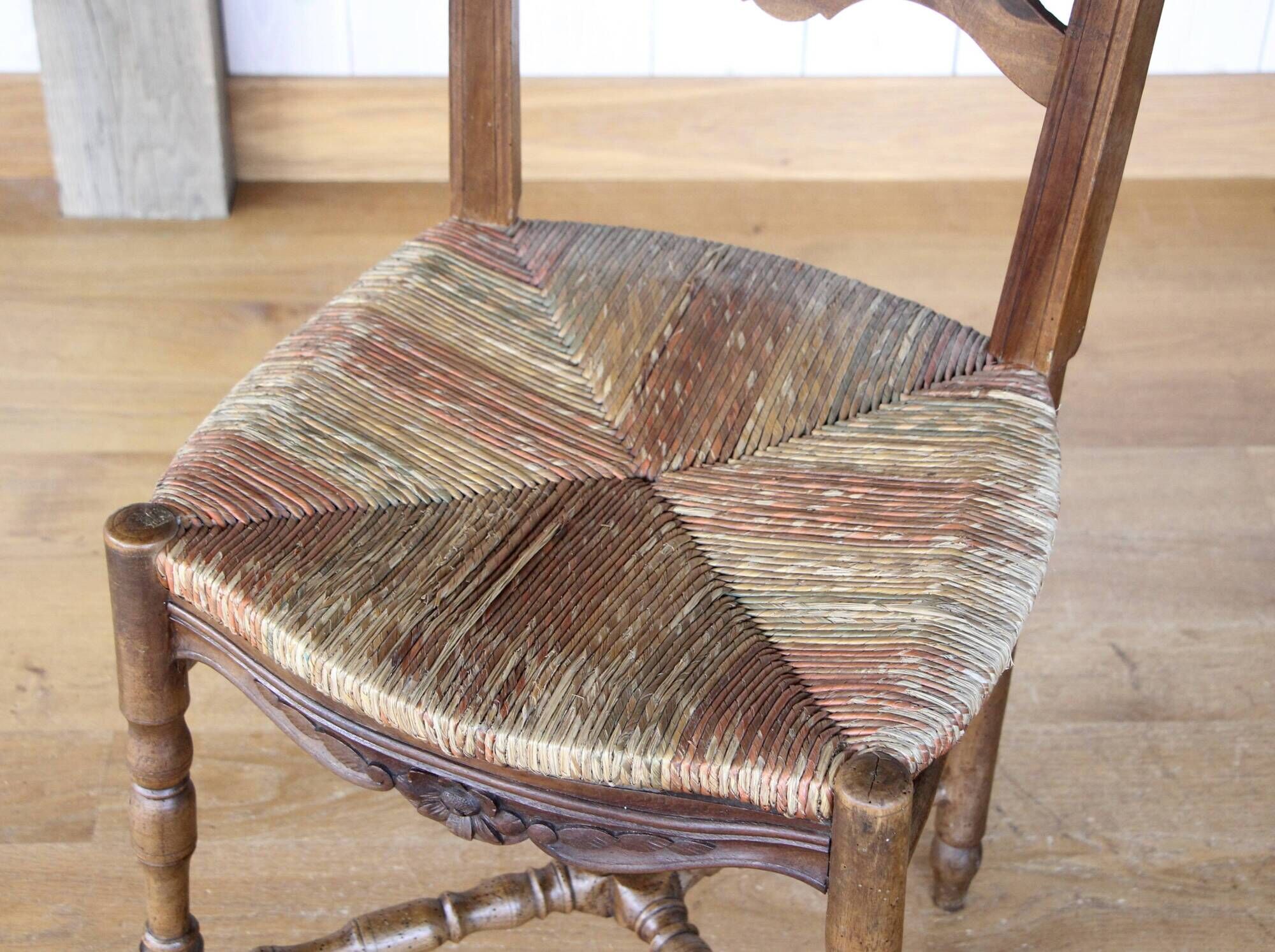 Antique chair with coloured rush seating.