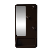 Wall mirror in moulded plastic with hooks and shelf.