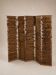 Wooden screen with slats, black plant decoration.