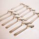 Silver plated metal service: 12 soup spoons, 12 forks and ladle.