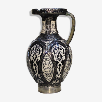 A jar of water pitcher made of tamgroute pottery handmade and adorned with bones.
