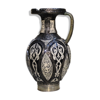 A jar of water pitcher made of tamgroute pottery handmade and adorned with bones.