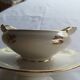 Sells sauceboat Elegant decoration of small golden roses,