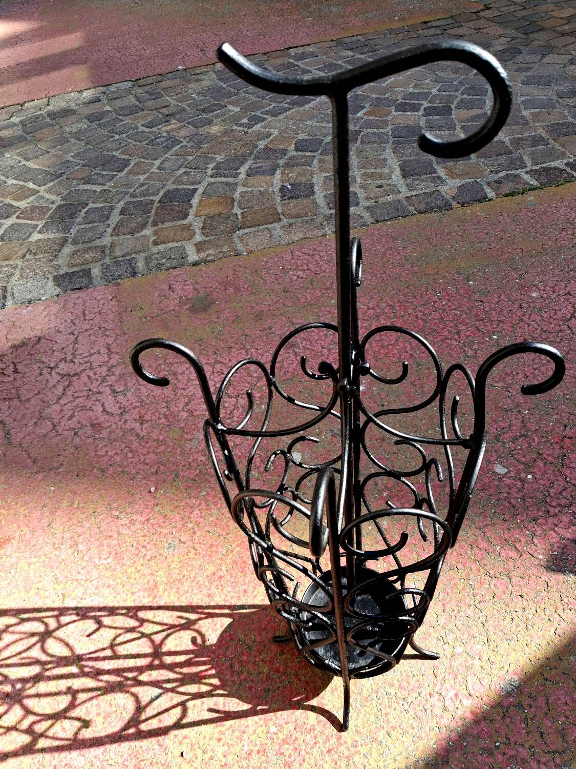 Antique wrought iron umbrella stand for entrance hall, vintage decor.