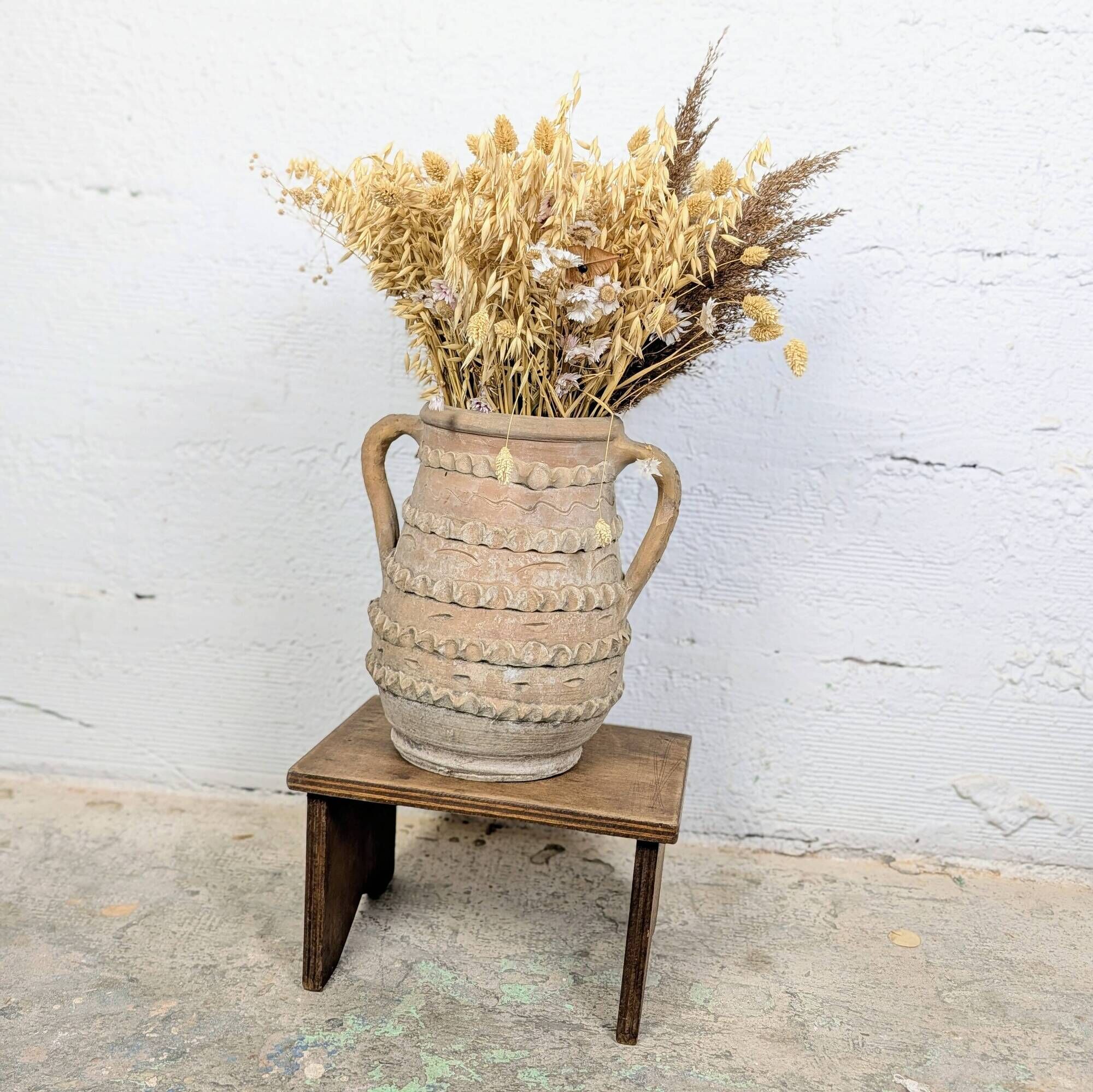Terracotta jar with two handles, decorated with garlands.