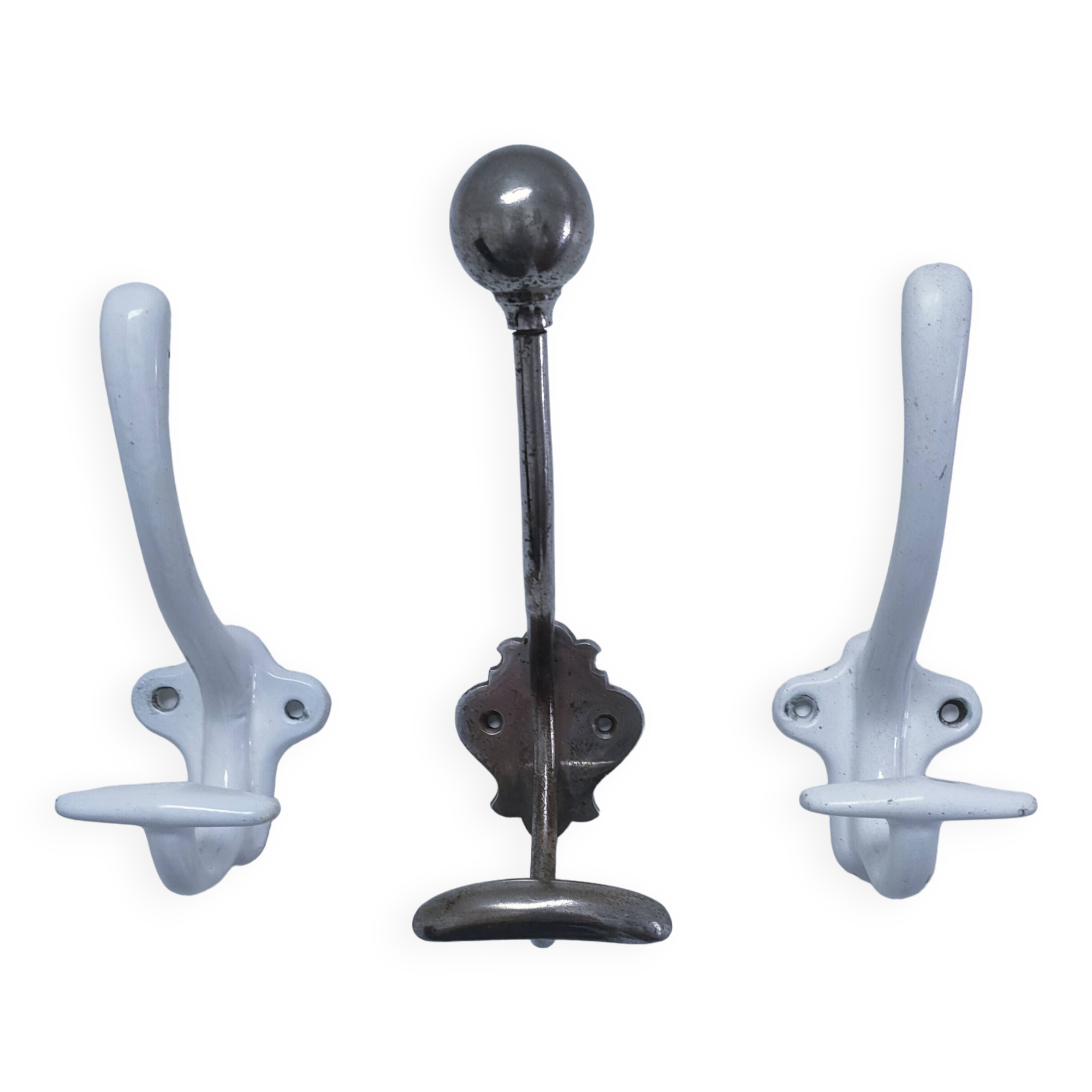 Three enameled cast iron coat hooks and vintage patina metal