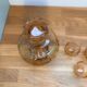 Carafe and 5 pink glass liqueur glasses with a gold rim 2008123