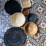 Set of 7 black and natural wicker baskets.