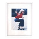 Framed photograph of Farrah Fawcett on a skateboard, 1976, digital print.