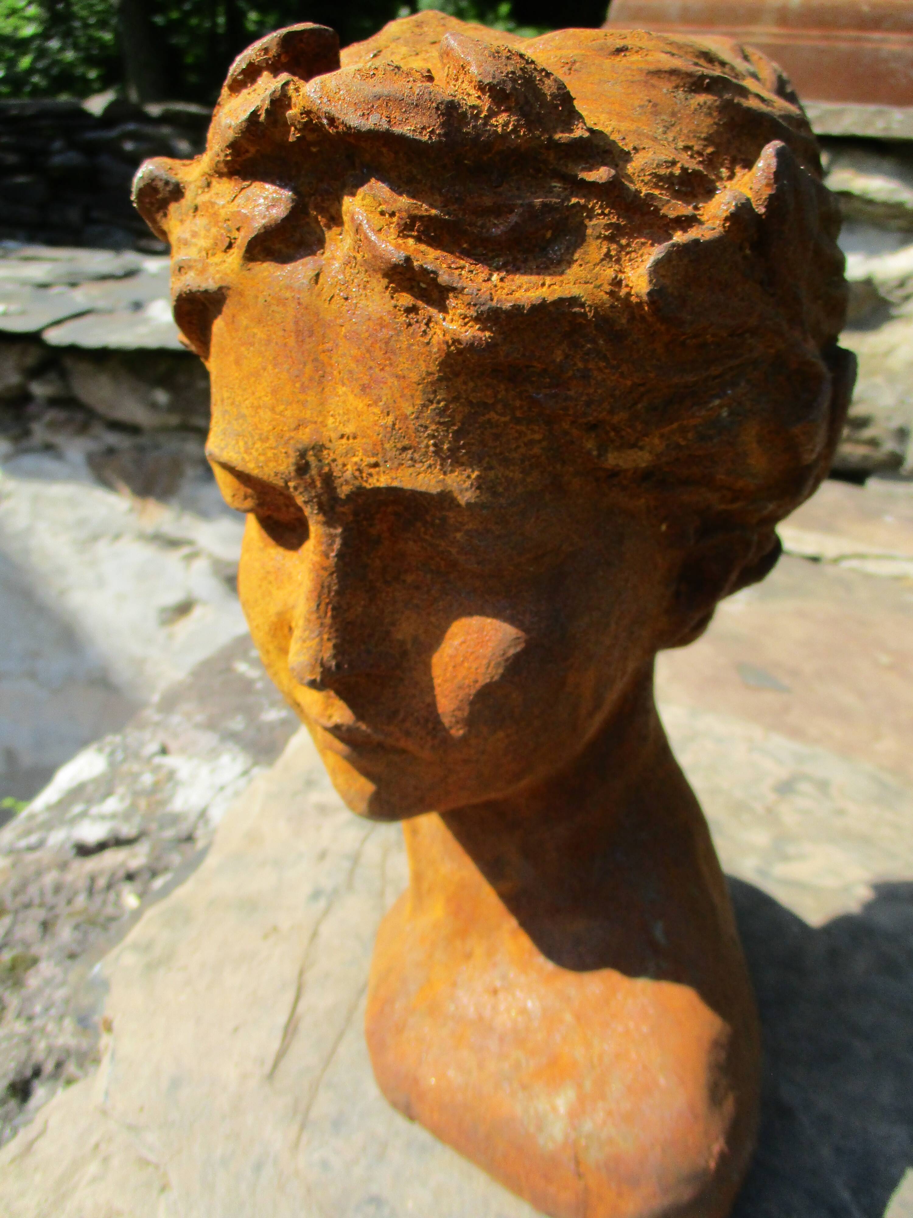 Cast iron sculpture of a woman.