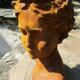 Cast iron sculpture of a woman.