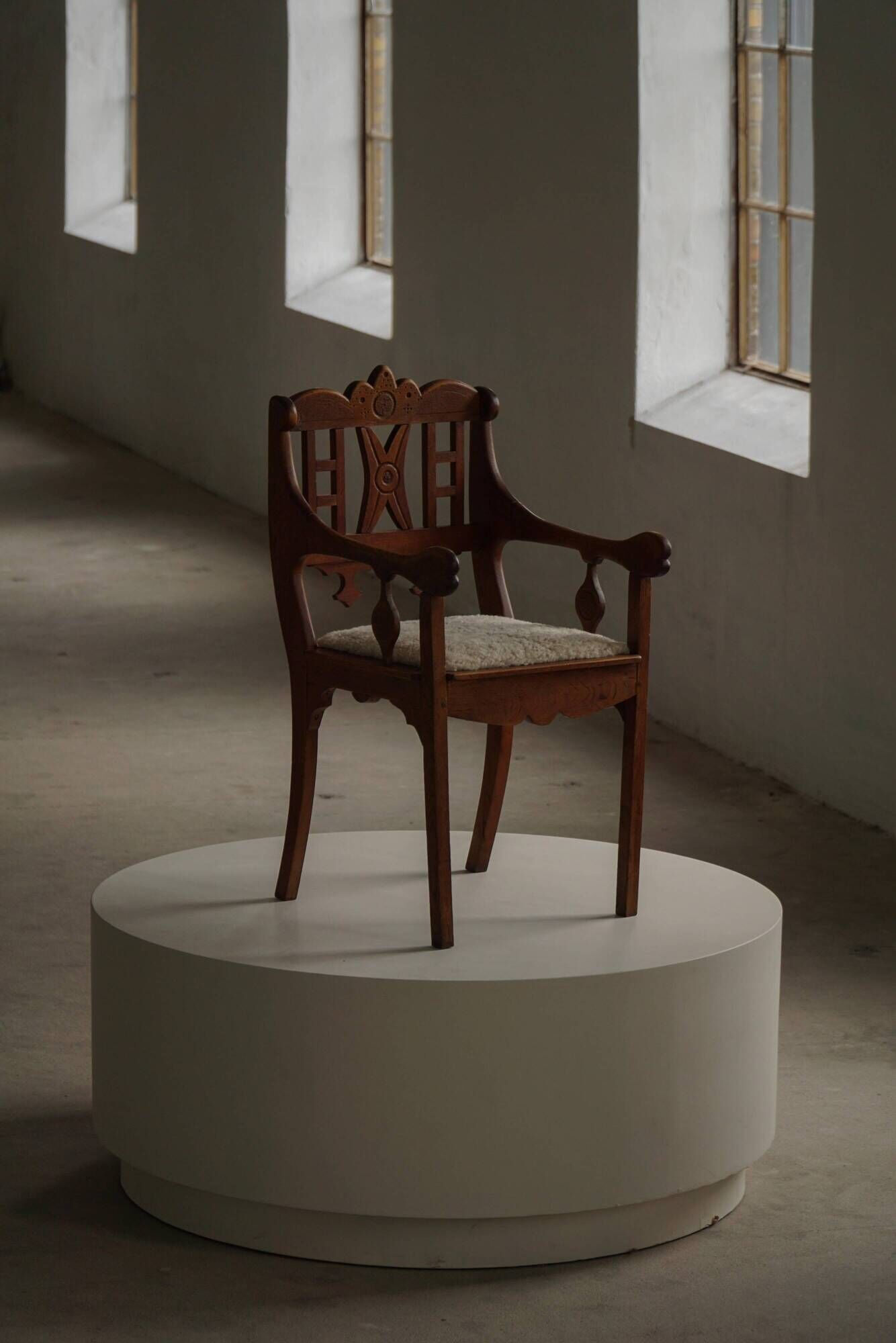 Danish popular art armchair in oak with a lambswool seat, early 20th century, 1930s.