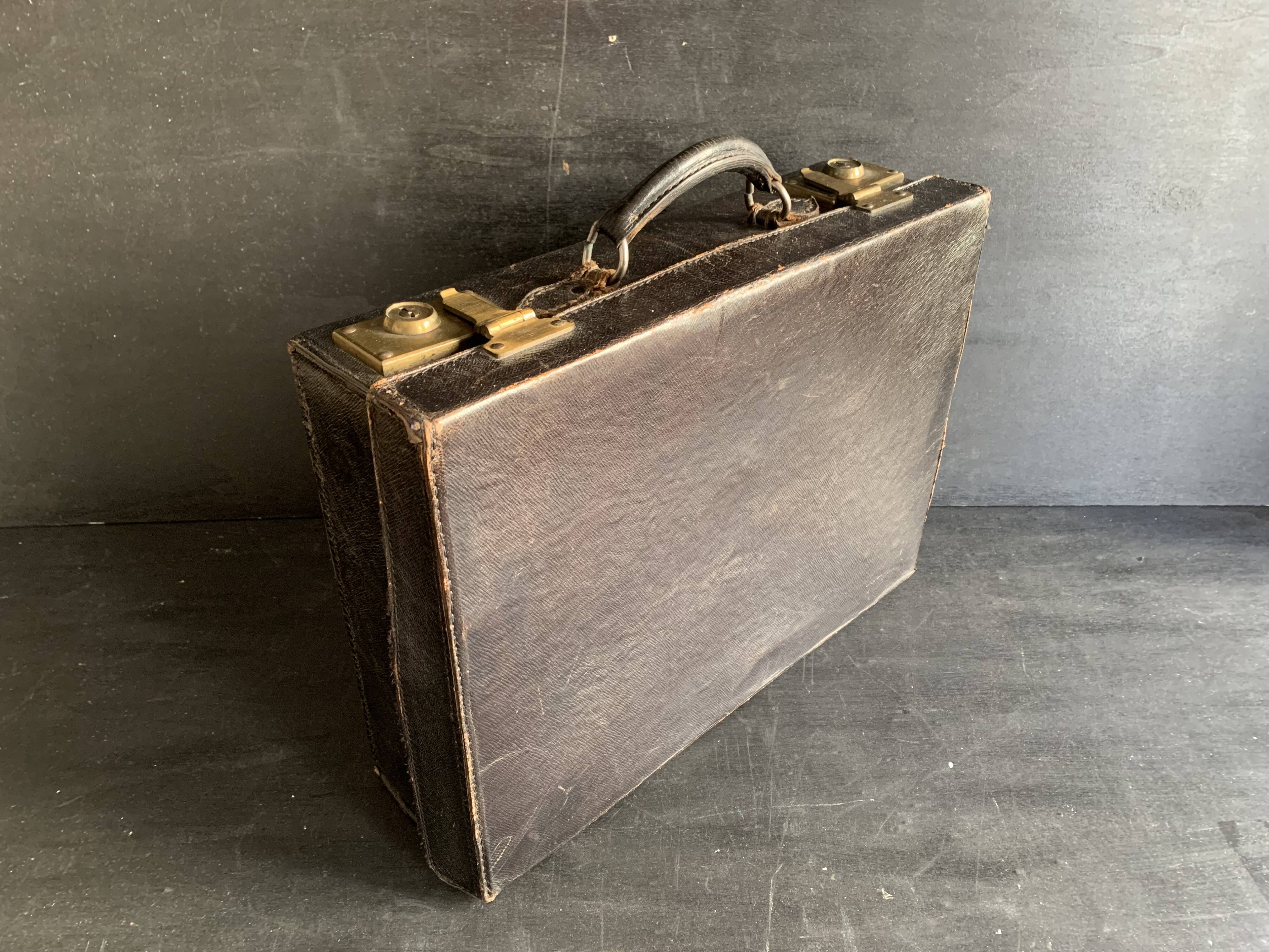 Small black grained leather travel suitcase from the 1920s