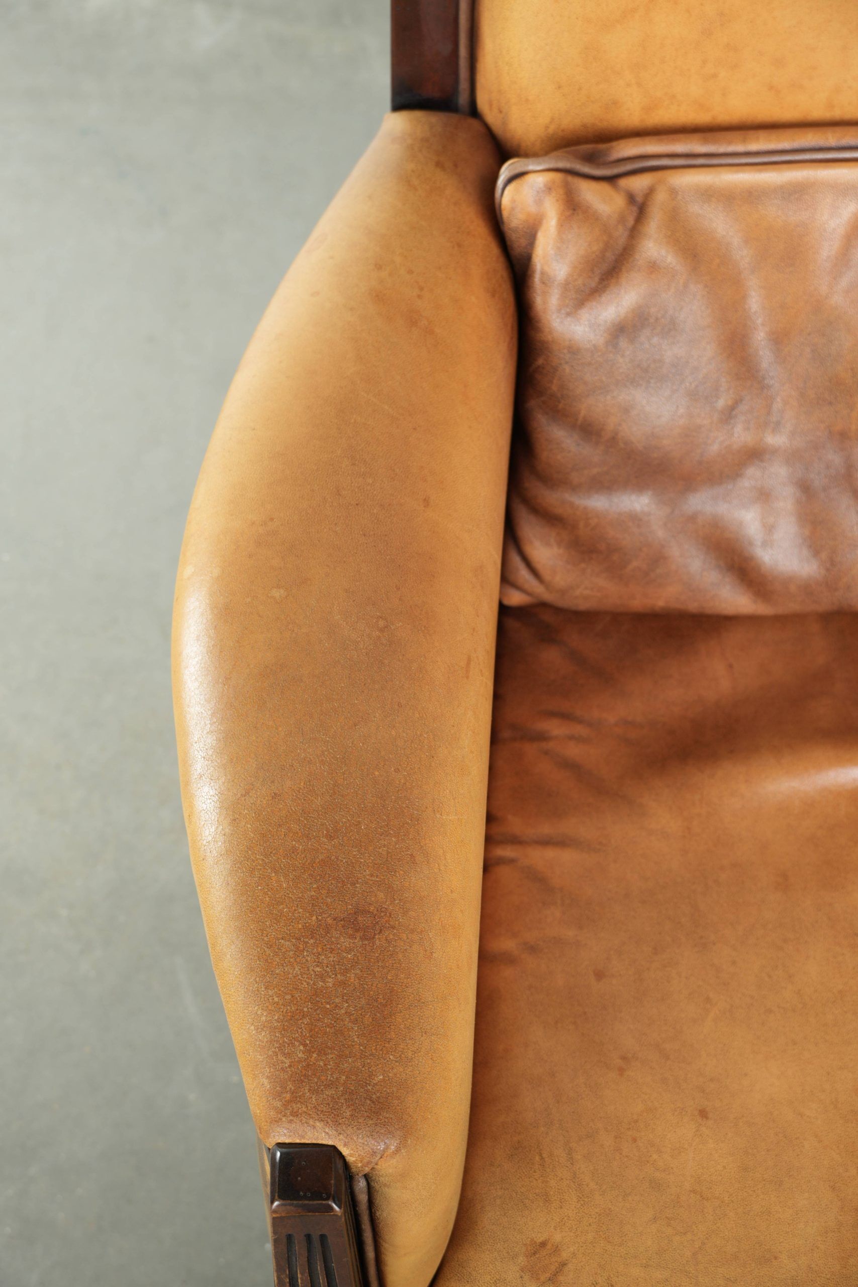 Cognac-coloured Art Deco design armchair made of sheepskin with a high back