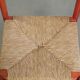 Nice red vintage wooden chair from the 1970s with a woven wicker seat