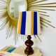 Vintage lamp with turned wooden base, striped wool lampshade