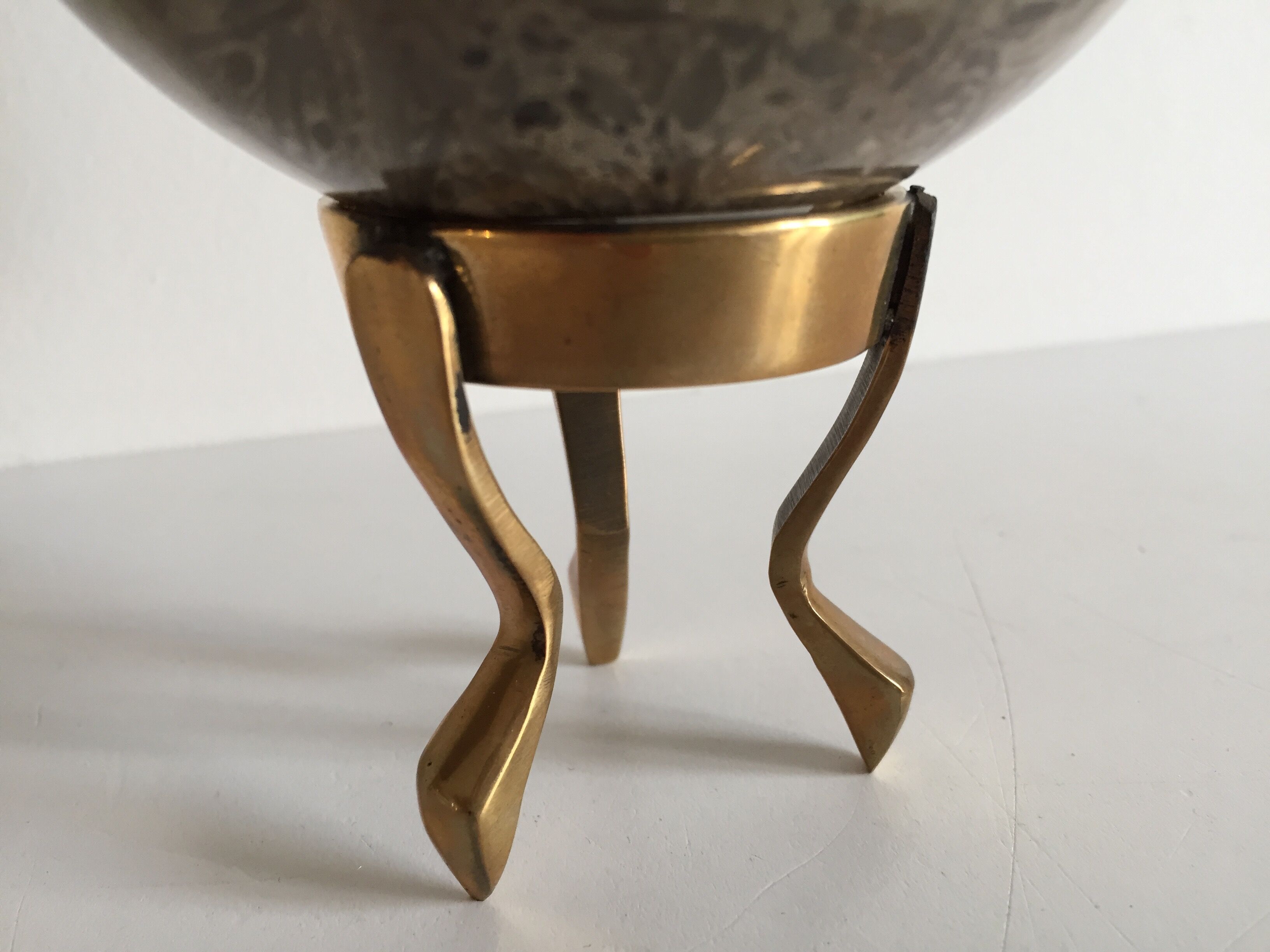 Marble ball paperweight on vintage brass