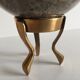 Marble ball paperweight on vintage brass
