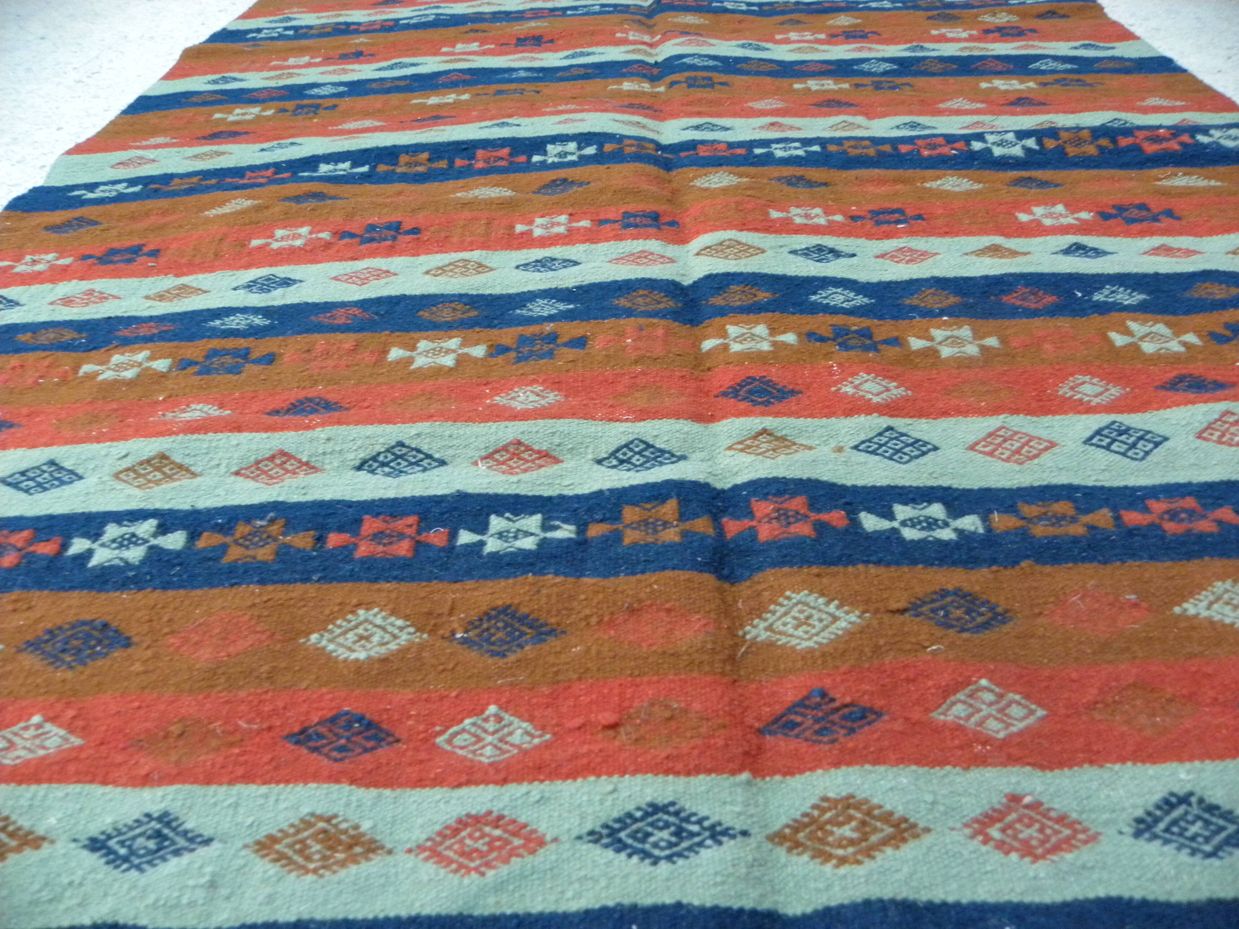 Authentic handmade Tunisian Berber kilim rug in orange wool.