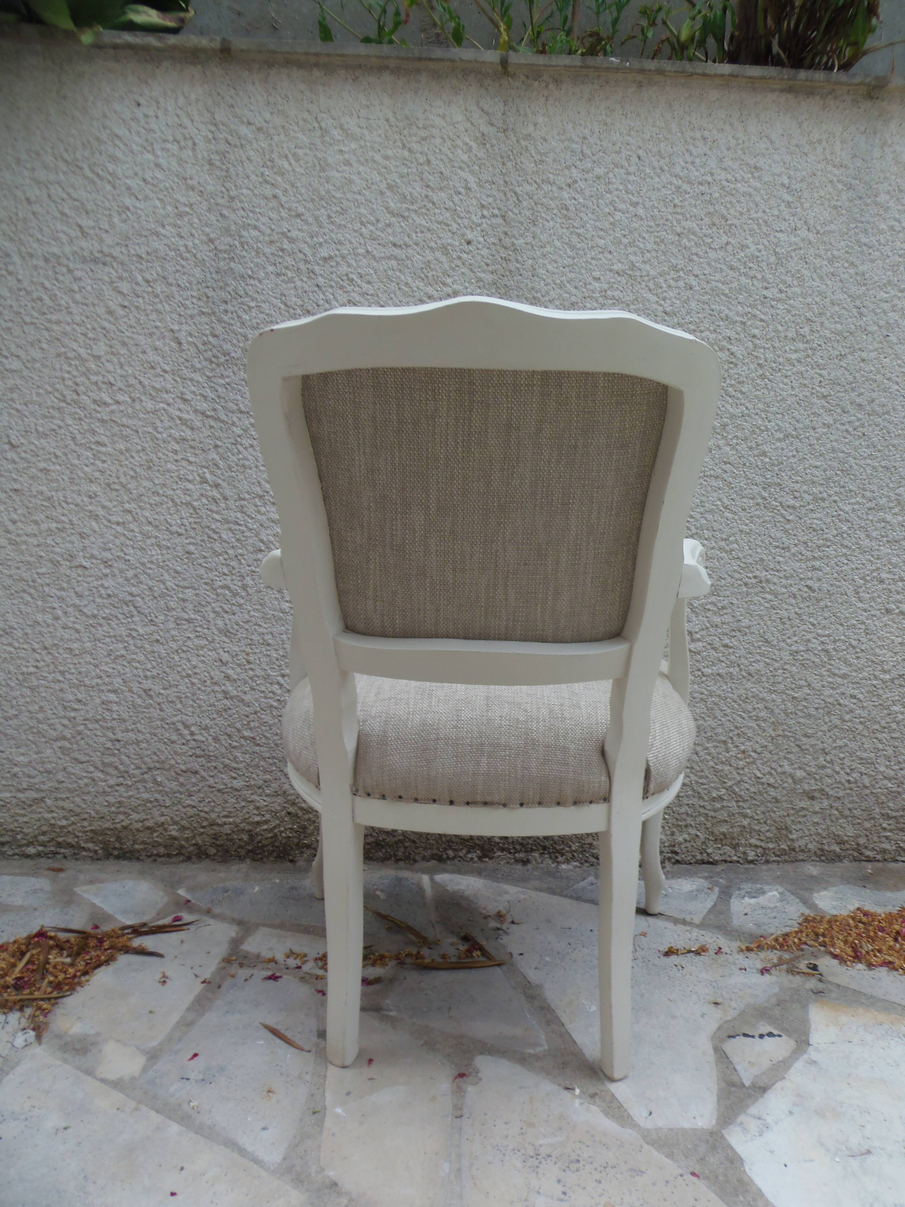 Louis XV style armchair in patinated beige, upholstered in beige fabric.