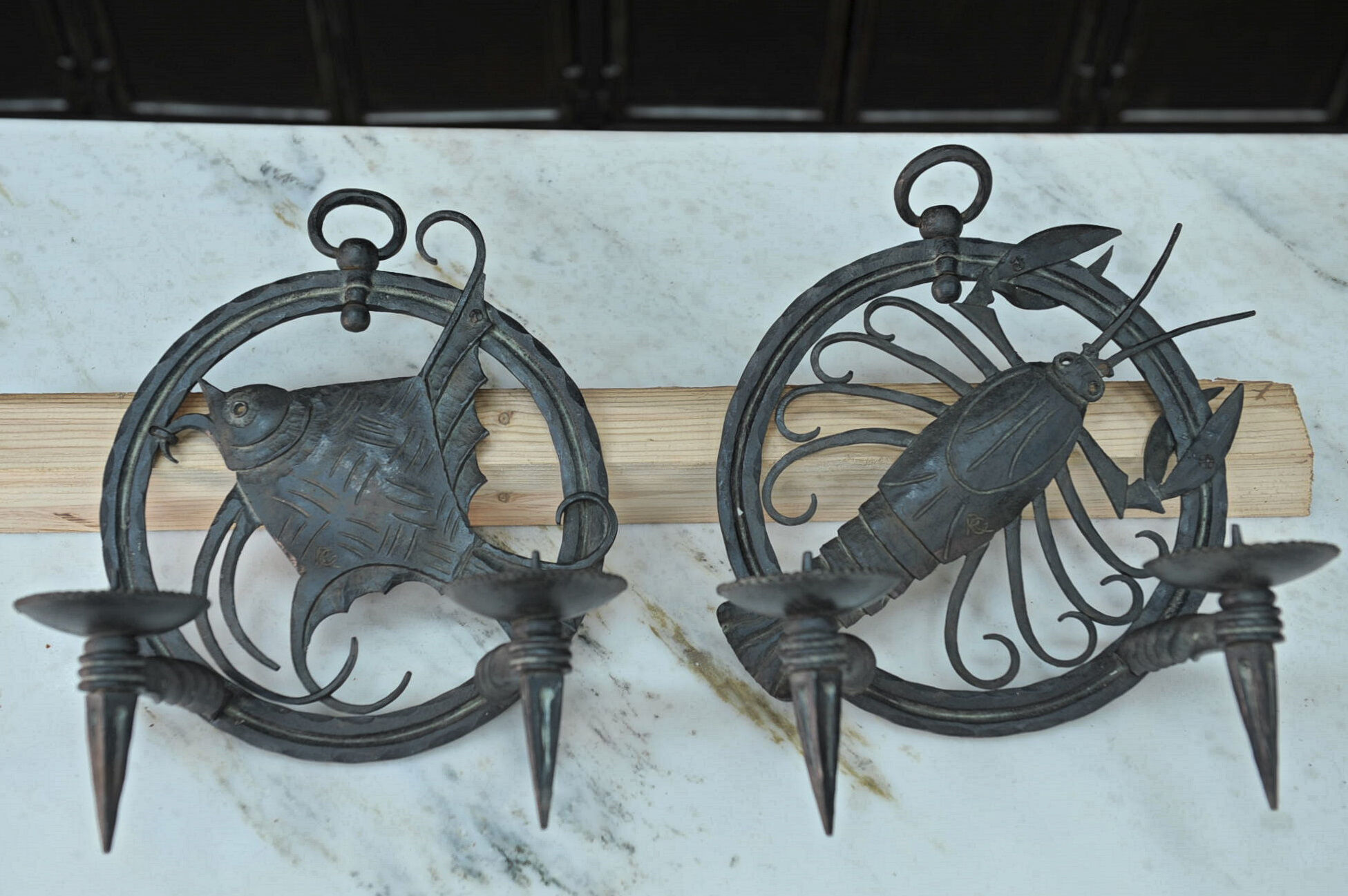 Pair of carved metal wall lamps signed RG