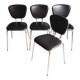 Set of 4 black synthetic leather chairs with pearlescent trim.
