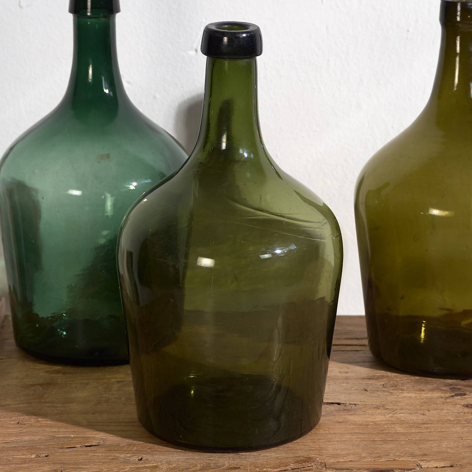 Antique green demijohns (circa 1920). Set of 3 pieces