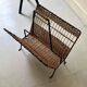 Porte revue en fer forgé noir et rotin dlg Raoul Guys, 1950