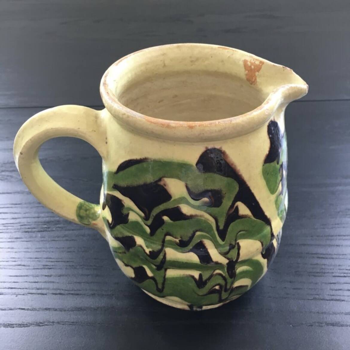 Antique pitcher of mixed earth