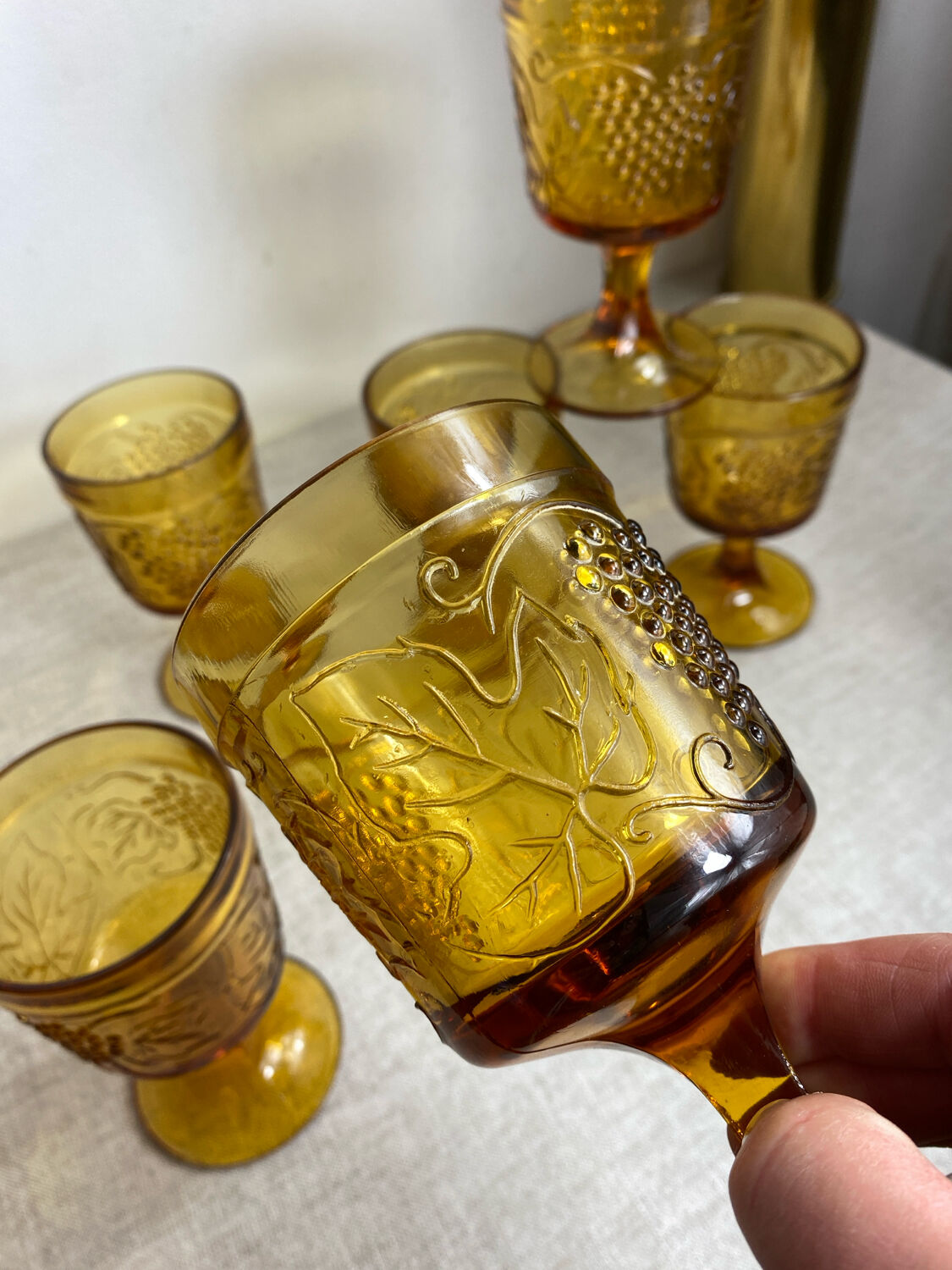 Six stemmed glasses in amber-colored molded glass