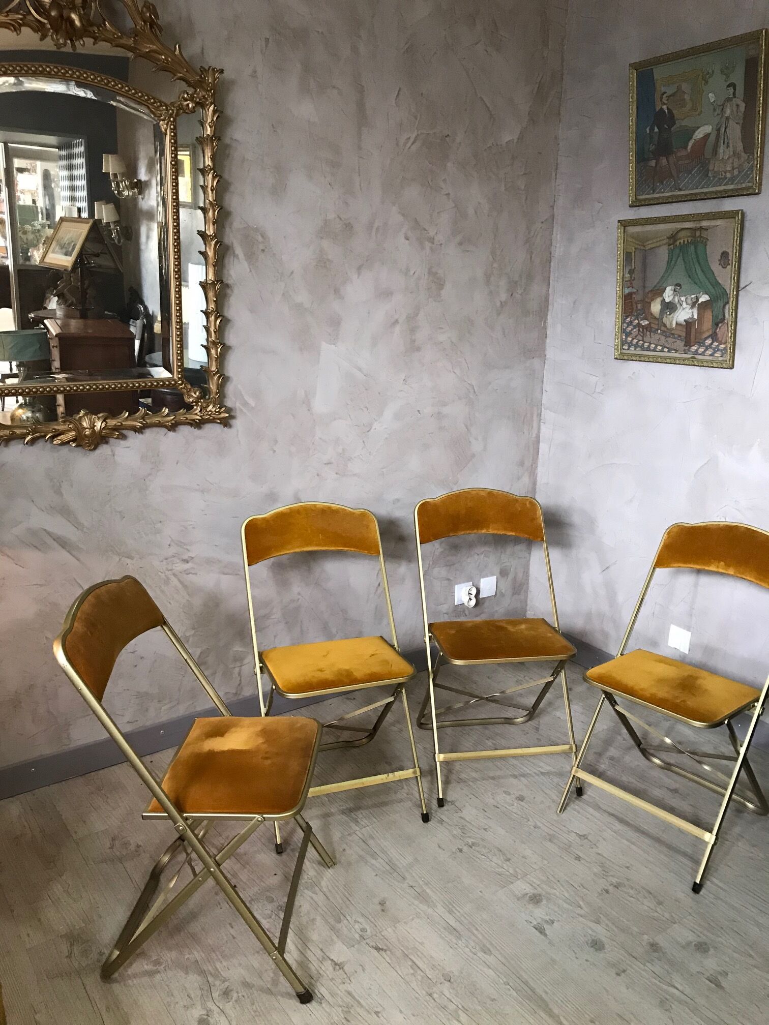 Four folding velvet and brass chairs