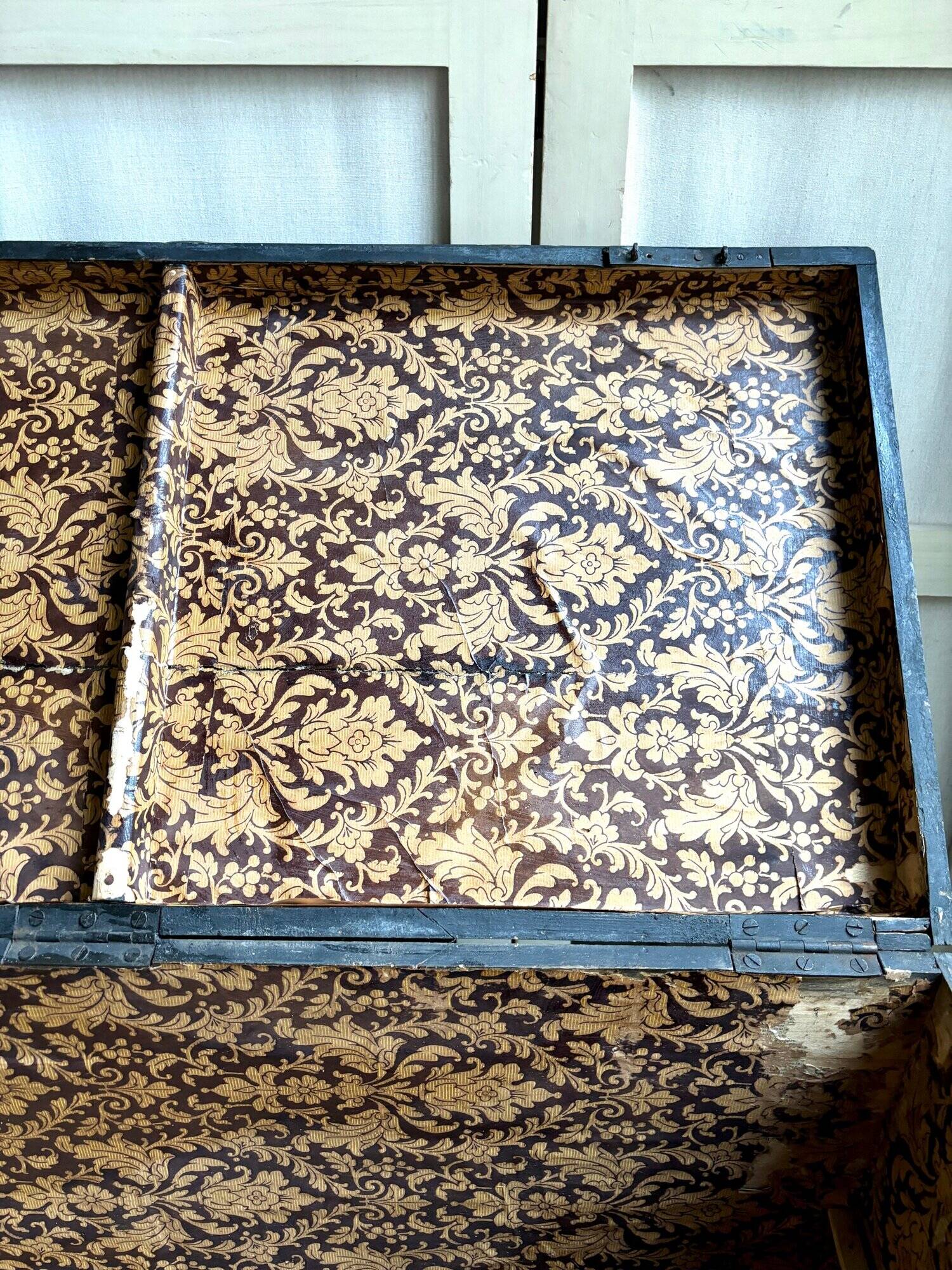 Trunk, black wooden chest and wallpaper