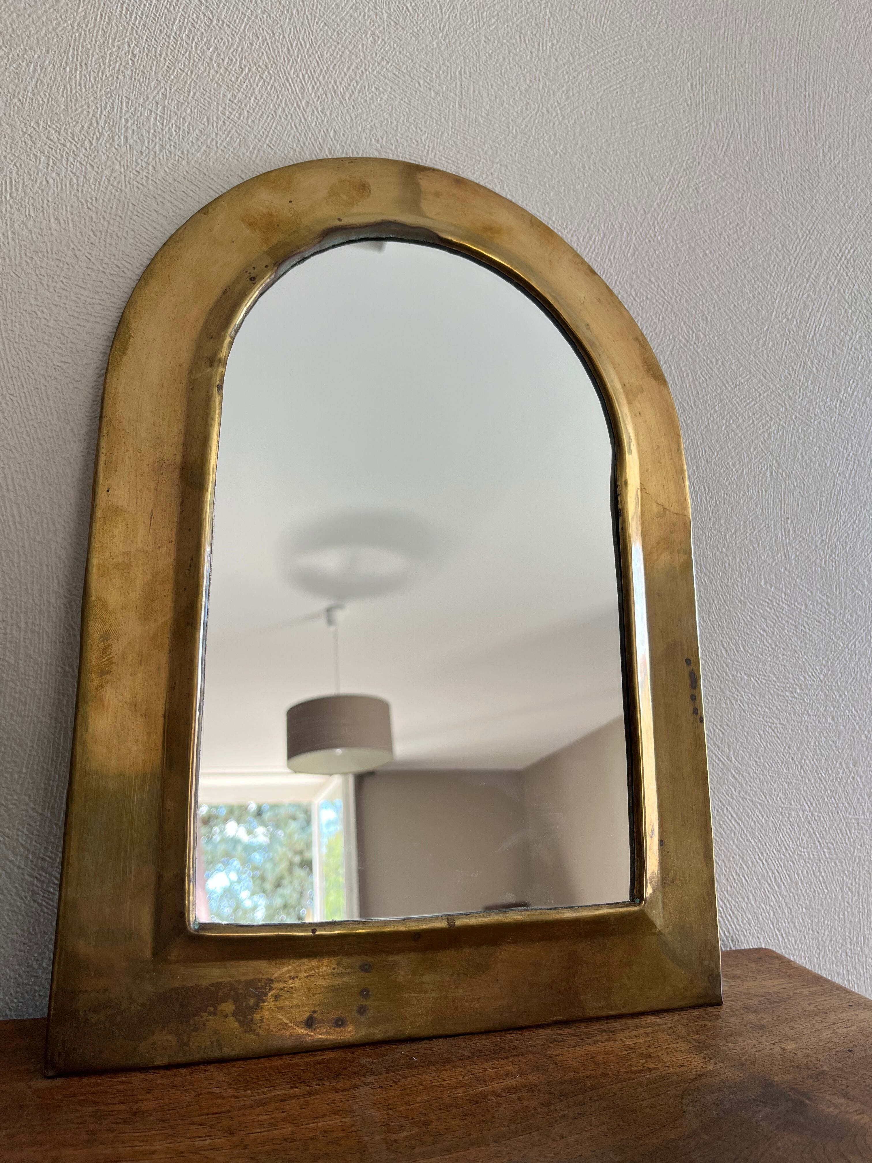 Brass half-moon mirror