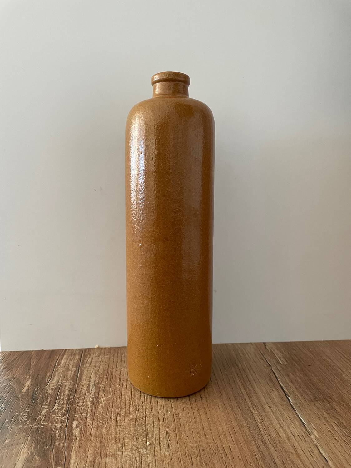 Old stoneware bottle with logo