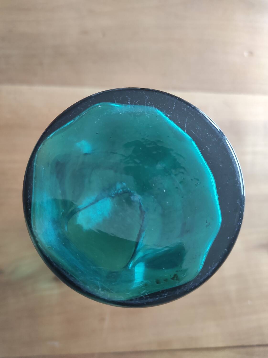 Blown glass vase with a flared neck and wavy rim.