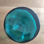 Blown glass vase with a flared neck and wavy rim.