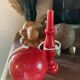 Large red wooden cup-and-ball game, 9 cm in diameter.