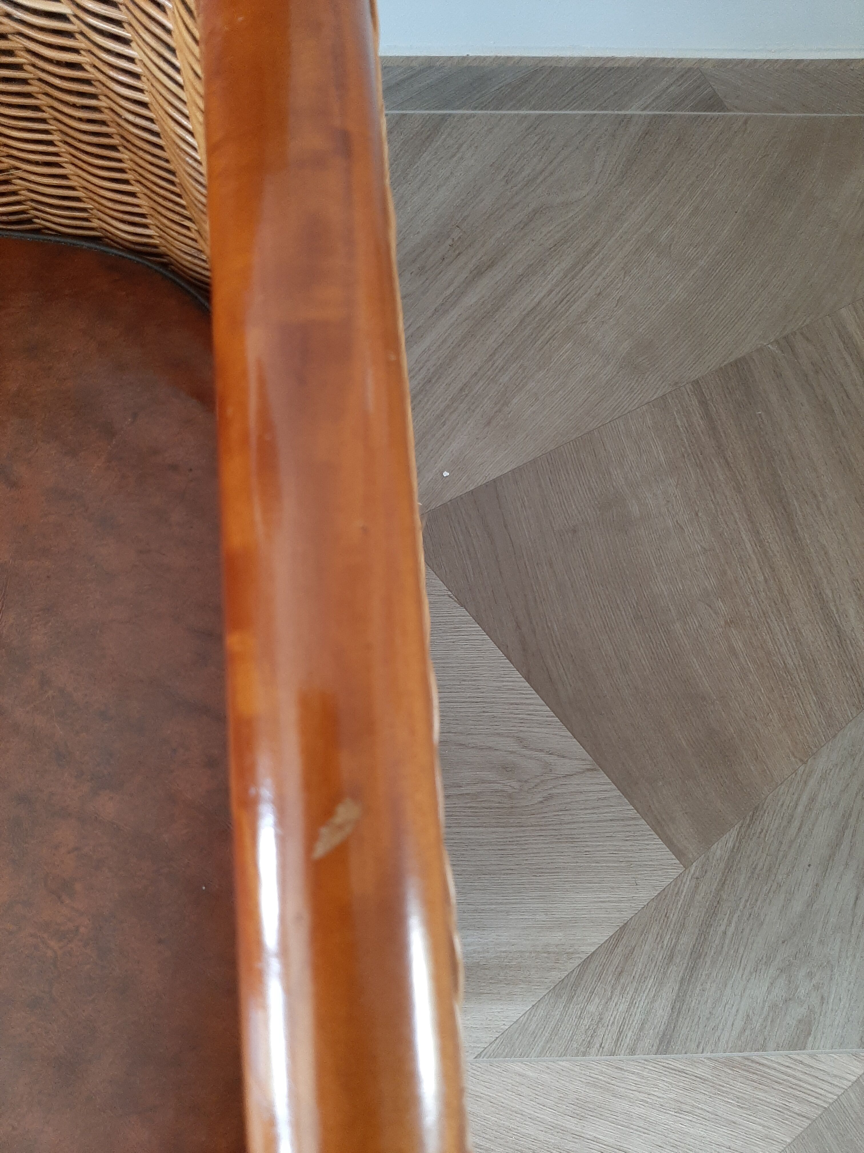 Armchair in woven rattan and exotic wood