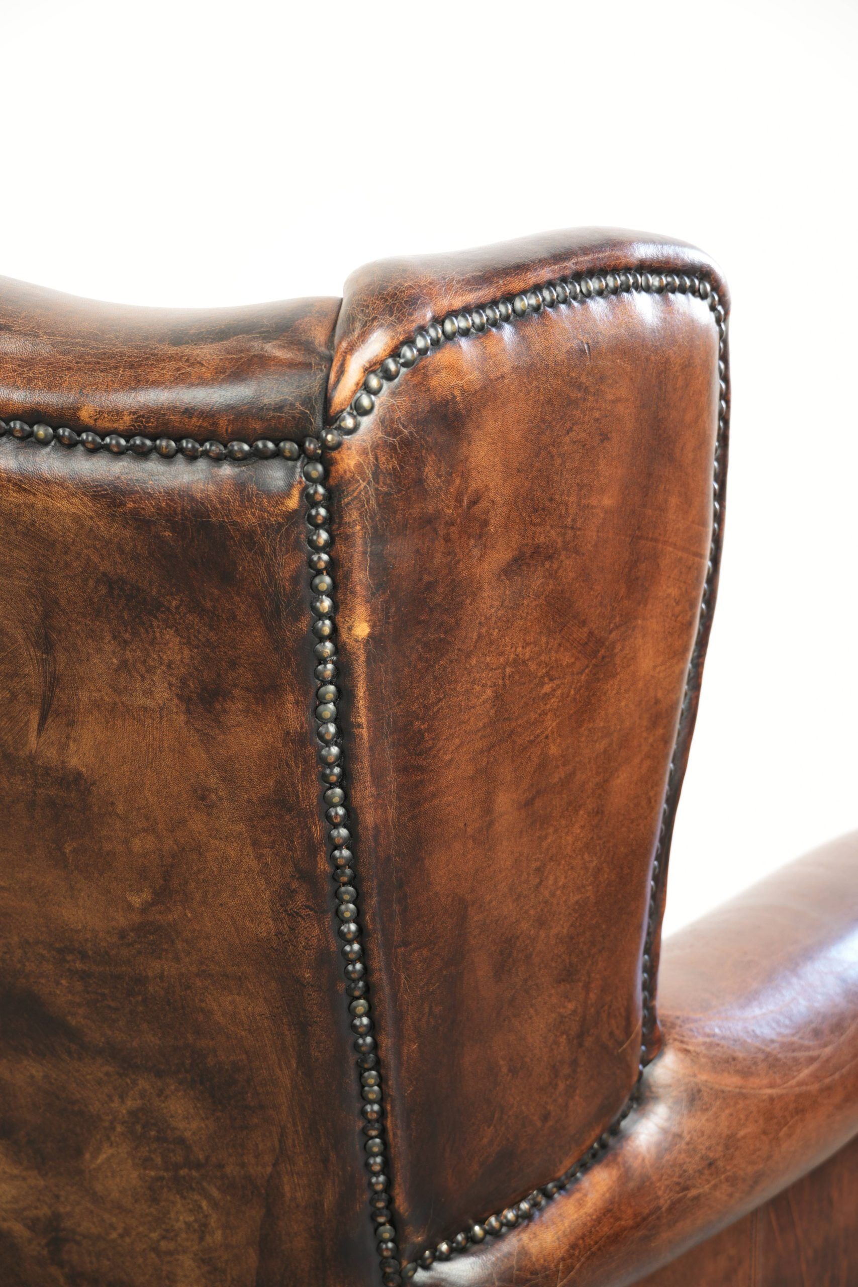 Vintage sheepskin wingback armchair in a deep brown colour finished