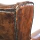 Vintage sheepskin wingback armchair in a deep brown colour finished