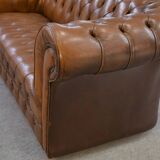 Fawn-colored tufted Chesterfield sofa