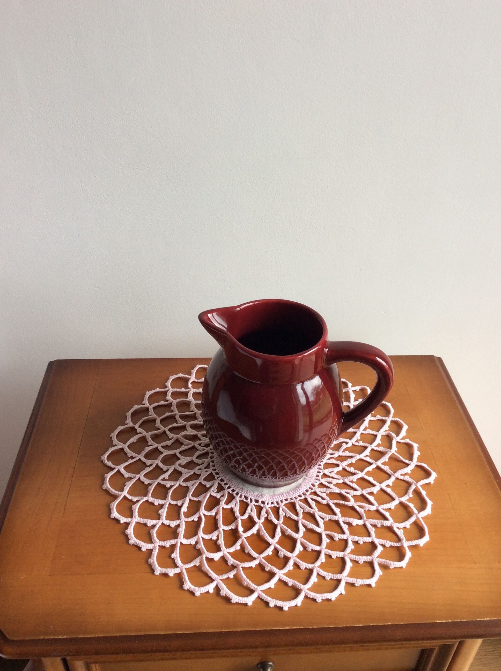 Old dark red ceramic pitcher jug