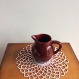 Old dark red ceramic pitcher jug