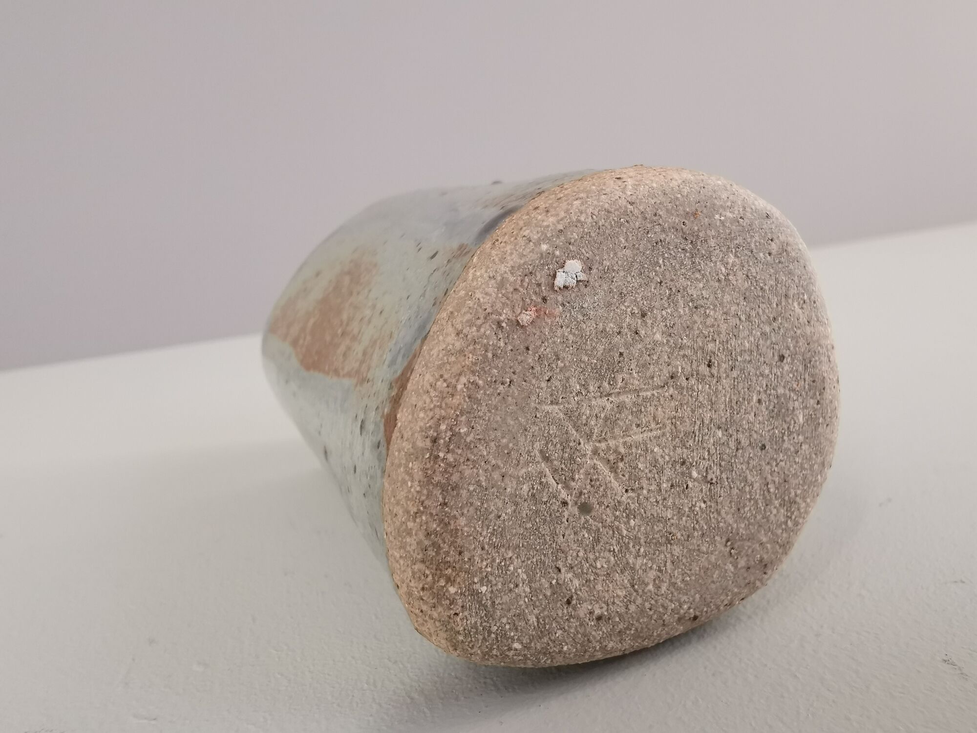 Signed vase in enamelled sandstone with stylized face