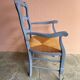 Provencal style straw armchair with gray blue patina armrests