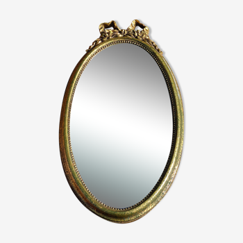 Golden oval mirror with knot