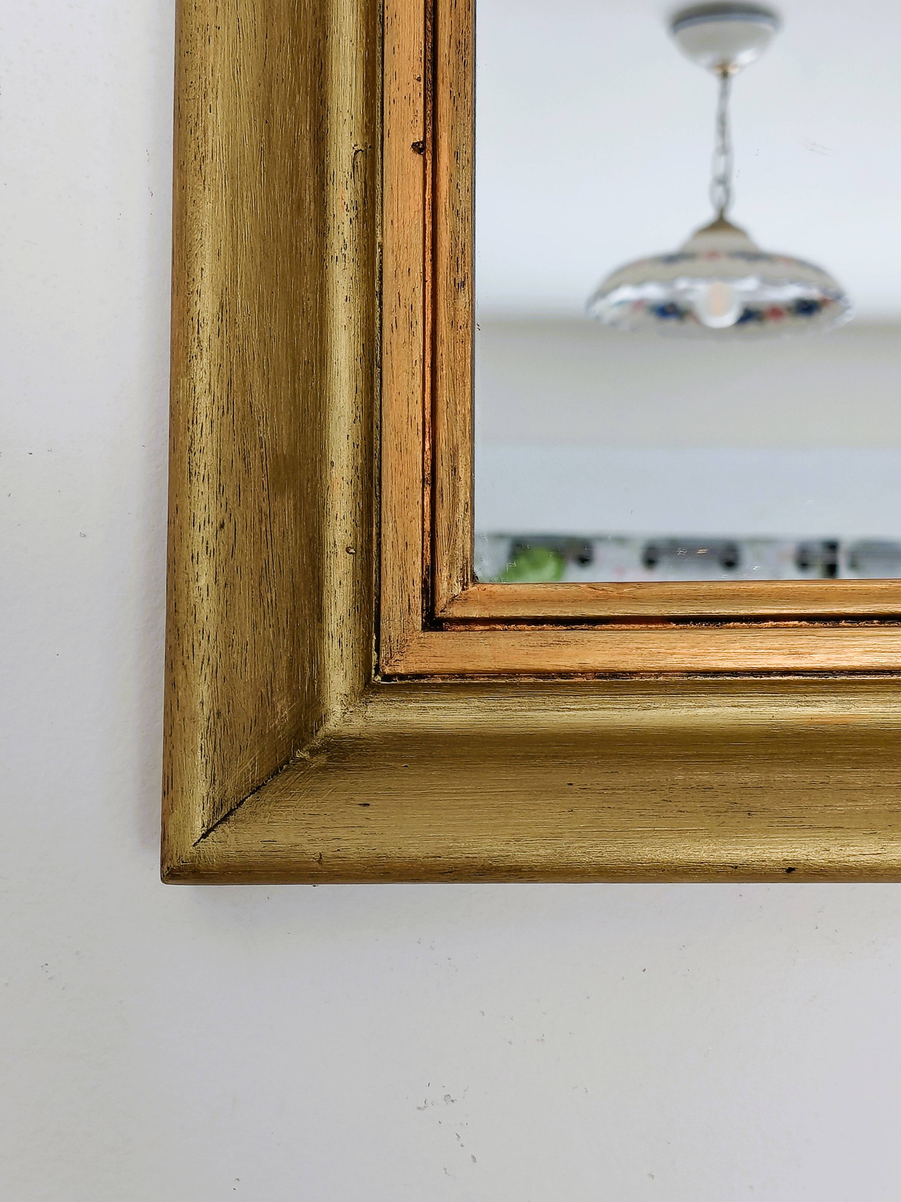 Antique mirror in gilded and copper wood