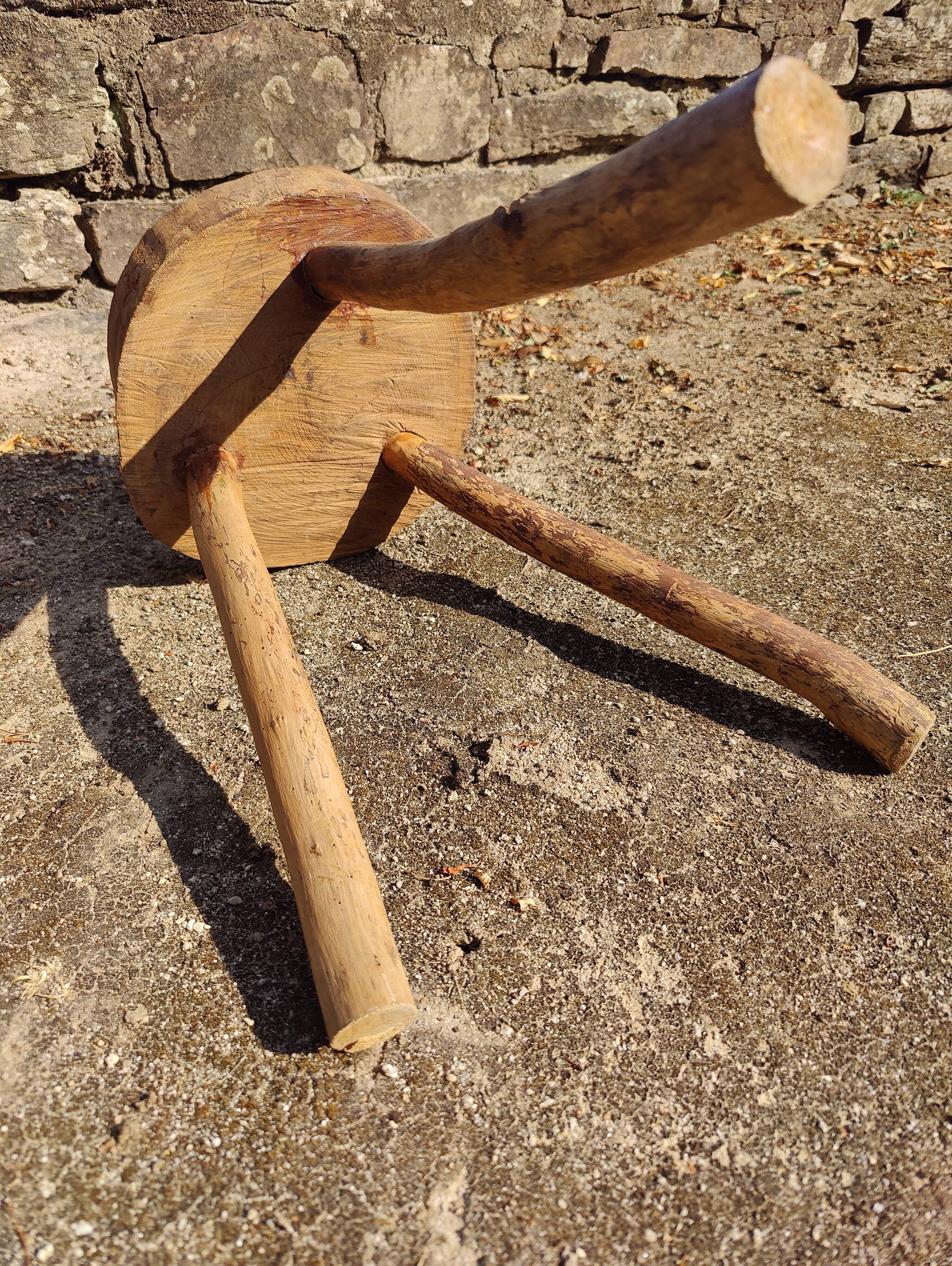 Rustic three-legged stool in minimalist wood in the style of Touret.